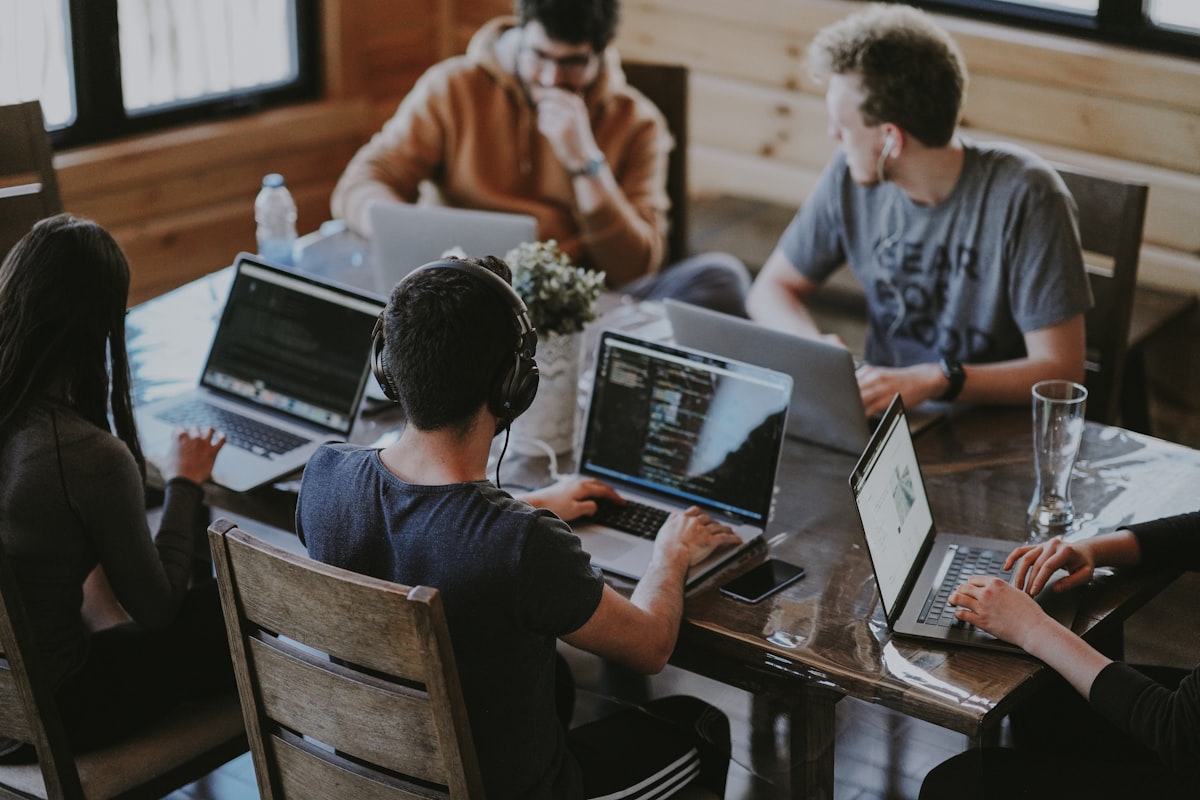 Professionals collaborating at a laptop
